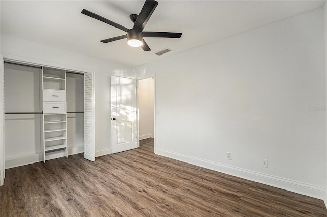 unfurnished bedroom with hardwood / wood-style flooring, ceiling fan, and a closet