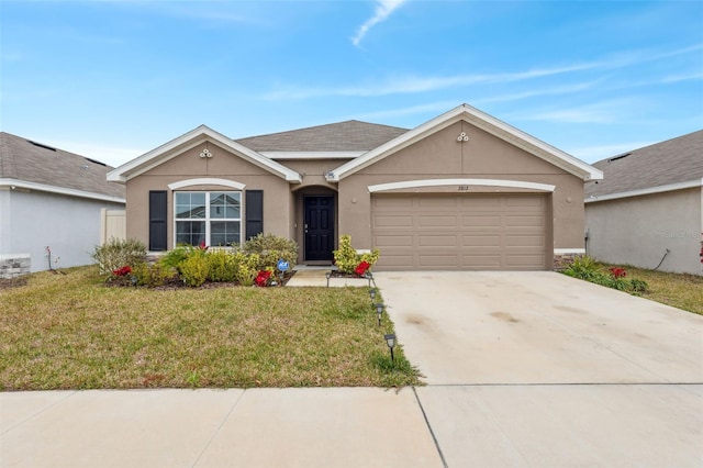 single story home featuring a garage and a front lawn