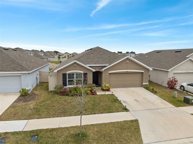 ranch-style home with a garage and a front lawn