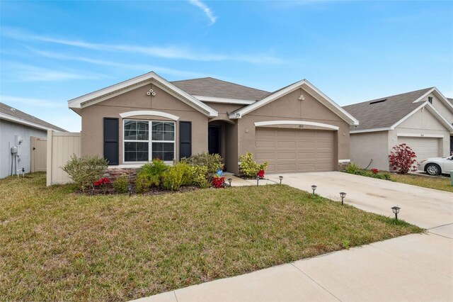 ranch-style home featuring a garage and a front yard