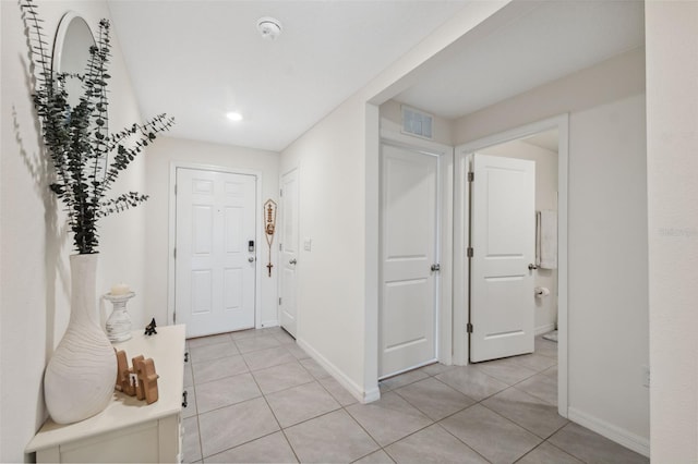 foyer entrance with light tile patterned flooring