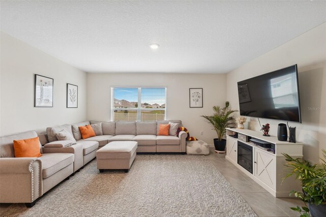 living room featuring a textured ceiling and light tile patterned flooring