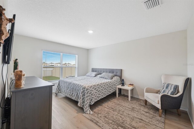 bedroom with light hardwood / wood-style floors