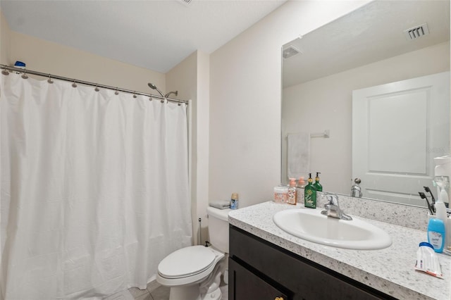 bathroom featuring vanity, walk in shower, and toilet