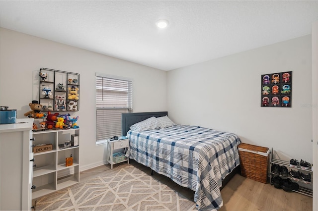 bedroom with hardwood / wood-style flooring