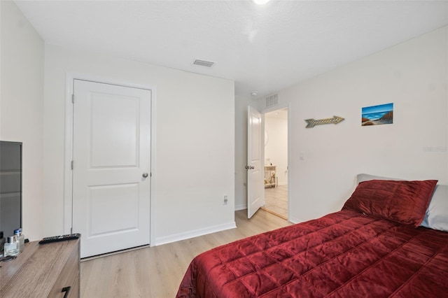 bedroom with wood-type flooring