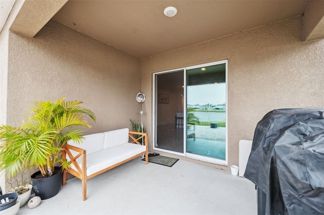 property entrance with a patio area and outdoor lounge area