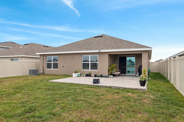 rear view of property featuring a yard and a patio area