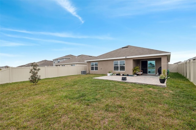 back of property featuring cooling unit, a lawn, and a patio area