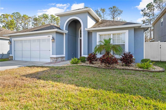 view of front of house with a garage and a front yard