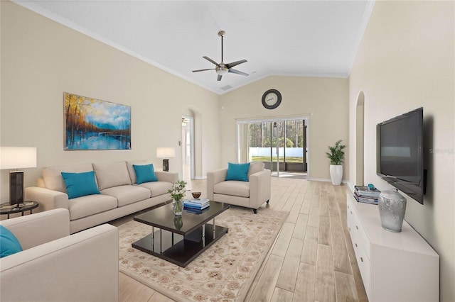 living room with lofted ceiling, light hardwood / wood-style flooring, ornamental molding, and ceiling fan