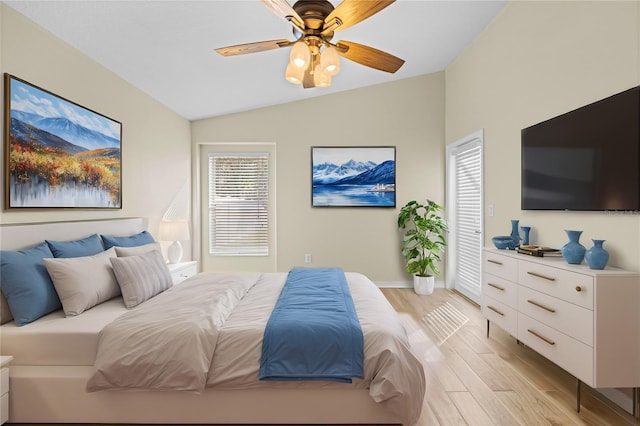 bedroom featuring lofted ceiling, light hardwood / wood-style floors, and ceiling fan