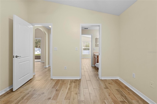 unfurnished room with vaulted ceiling and light hardwood / wood-style flooring