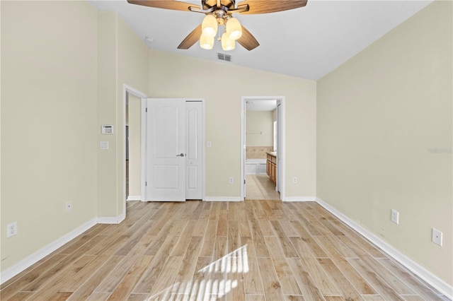 unfurnished bedroom featuring vaulted ceiling, ceiling fan, connected bathroom, and light hardwood / wood-style floors