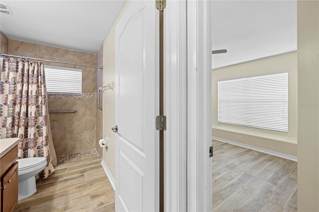 bathroom with vanity, toilet, curtained shower, and wood-type flooring