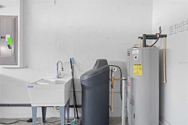 utility room with sink, electric panel, and water heater