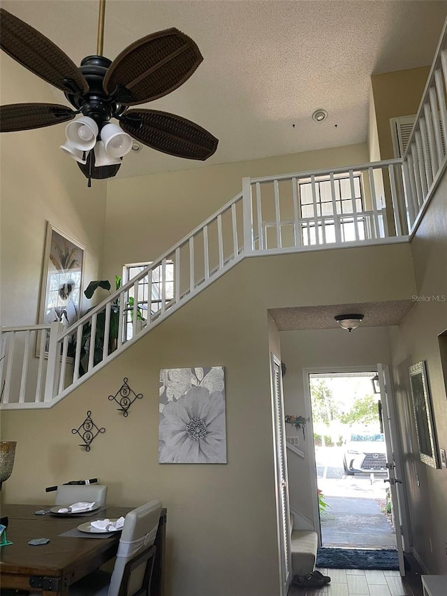 interior space featuring a textured ceiling and a high ceiling