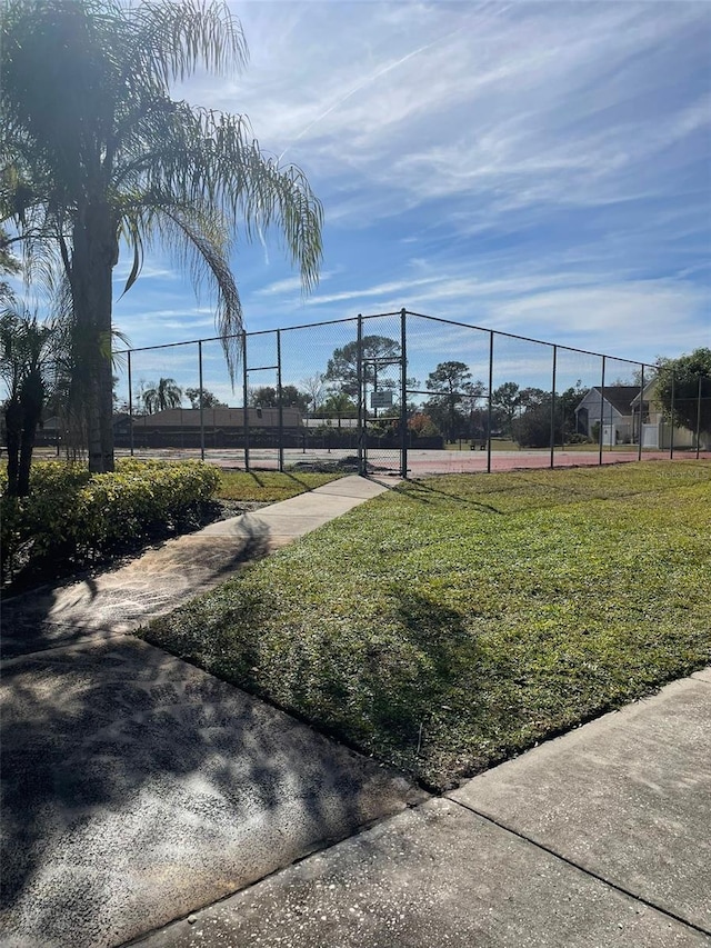 exterior space featuring a yard and tennis court