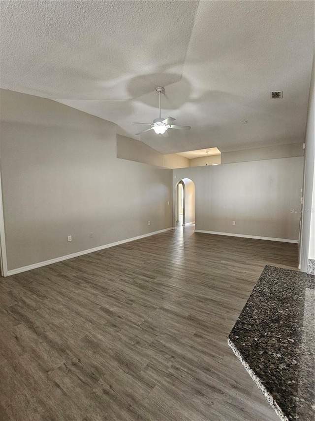 unfurnished living room with dark hardwood / wood-style flooring, a textured ceiling, and ceiling fan