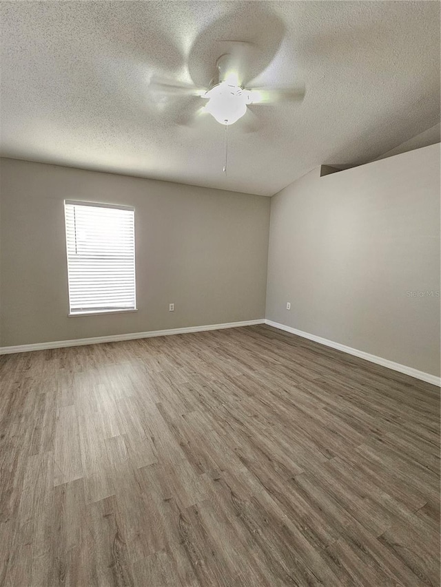 unfurnished room featuring a textured ceiling, wood-type flooring, and ceiling fan