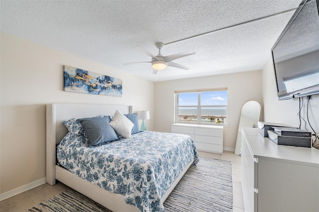 bedroom with a textured ceiling and ceiling fan