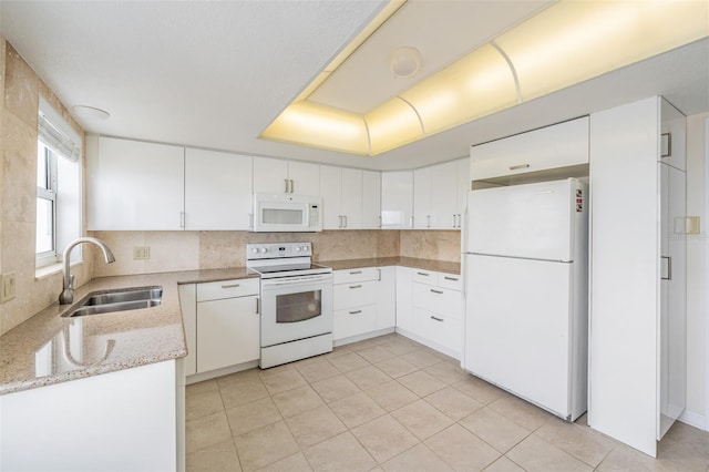 kitchen with tasteful backsplash, sink, white cabinets, and white appliances