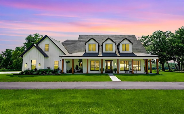 view of front of house with a yard and covered porch