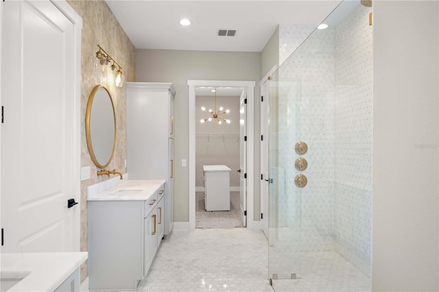 bathroom featuring tile patterned flooring, vanity, a chandelier, and walk in shower