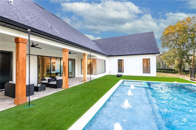 view of swimming pool with a yard, a patio area, outdoor lounge area, and ceiling fan