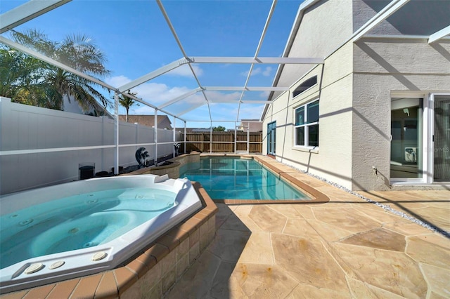 view of swimming pool featuring an in ground hot tub, a lanai, and a patio area