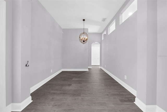 entryway featuring dark wood-type flooring and a notable chandelier