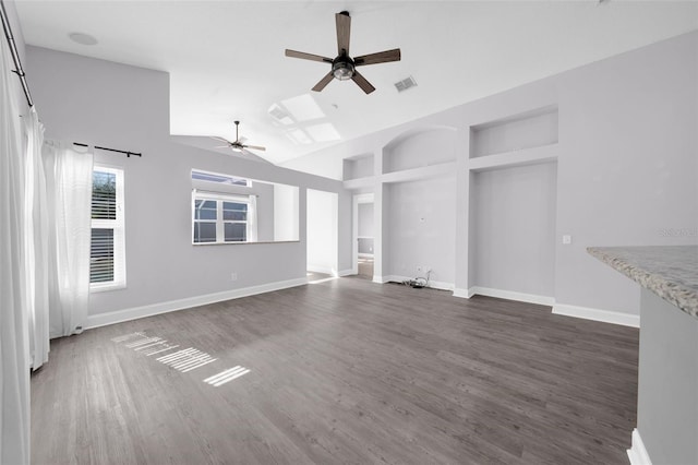 unfurnished living room featuring dark wood-type flooring, ceiling fan, and lofted ceiling