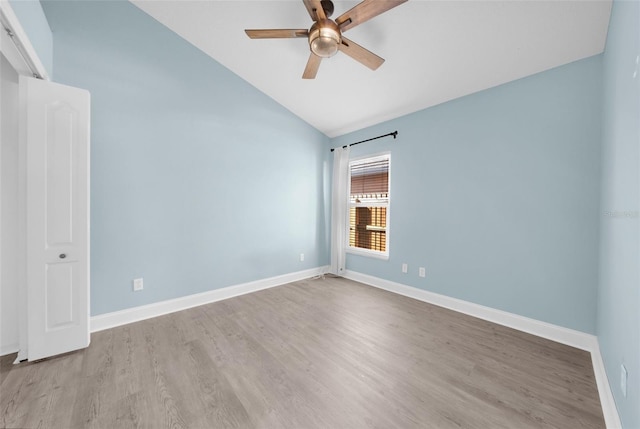 spare room with ceiling fan, lofted ceiling, and light hardwood / wood-style floors