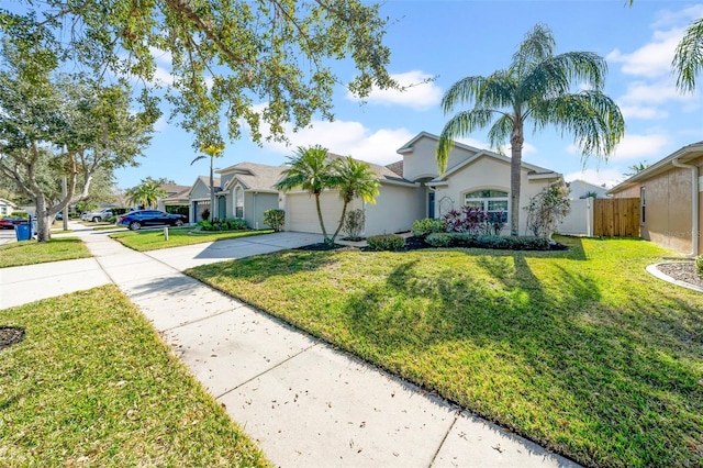 ranch-style home featuring a garage and a front lawn