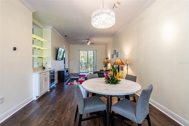 dining area featuring ornamental molding, dark wood-type flooring, ceiling fan with notable chandelier, and wine cooler