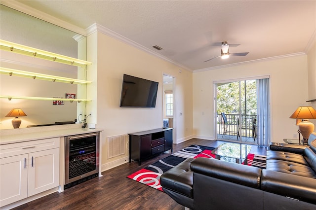 living room featuring wine cooler, crown molding, a textured ceiling, indoor bar, and dark hardwood / wood-style flooring