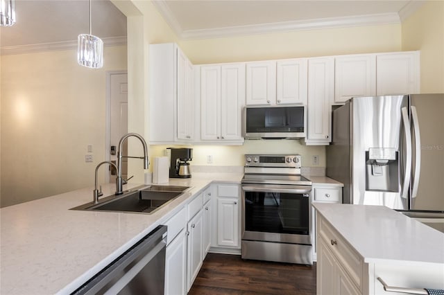 kitchen featuring dark hardwood / wood-style floors, white cabinetry, sink, hanging light fixtures, and stainless steel appliances