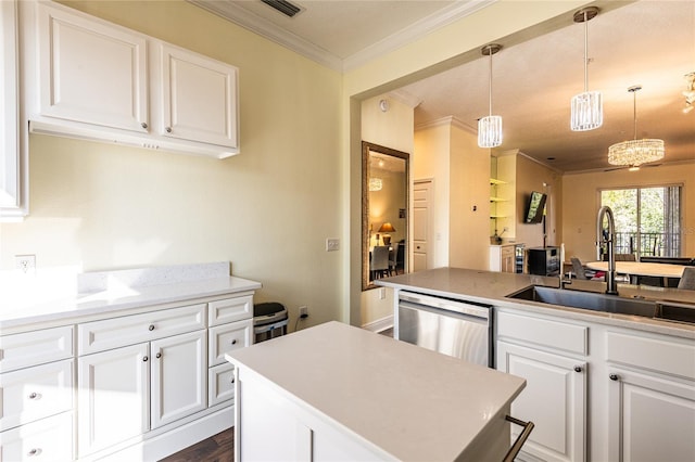 kitchen featuring pendant lighting, sink, dishwasher, white cabinetry, and a center island