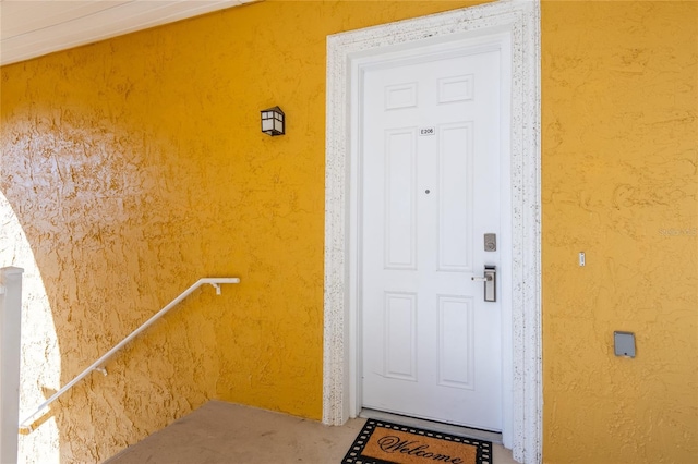 entrance to property with stucco siding