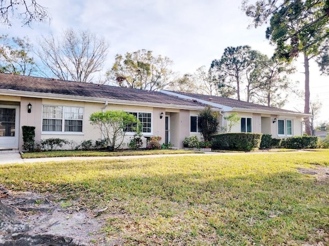 ranch-style house with a front lawn