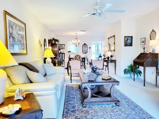 living room with carpet and ceiling fan with notable chandelier