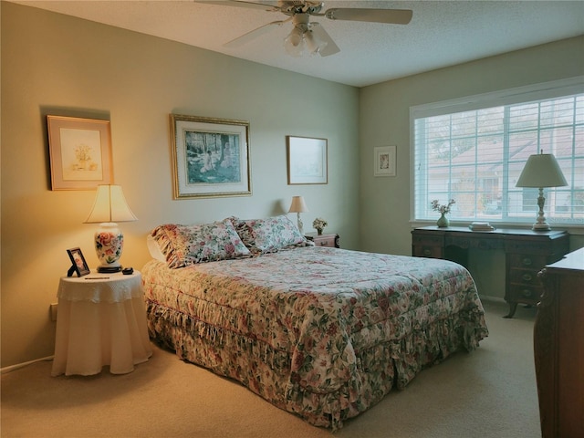 carpeted bedroom featuring a textured ceiling and ceiling fan