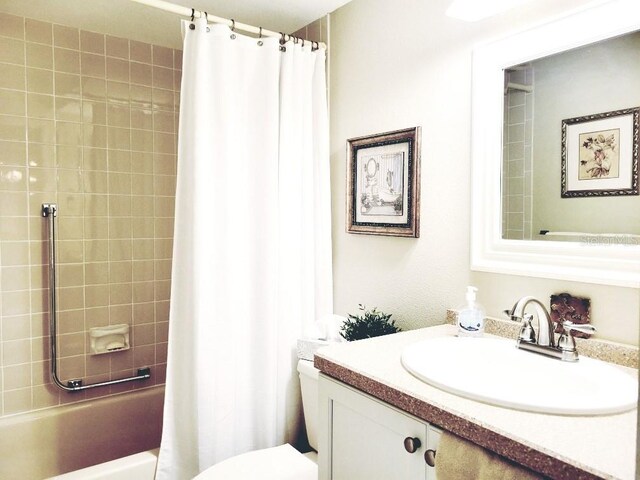 full bathroom featuring vanity, shower / bathtub combination with curtain, and toilet