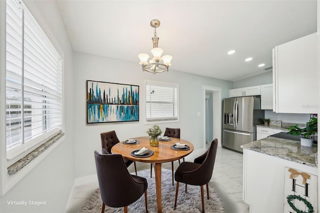 dining space with an inviting chandelier