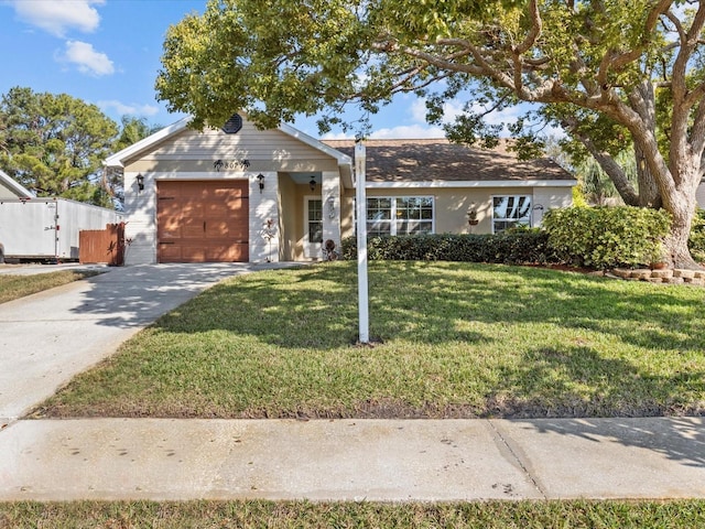 ranch-style house featuring a garage and a front lawn