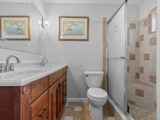 bathroom with vanity, toilet, and a shower with shower door