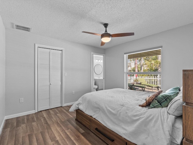 bedroom with ceiling fan, hardwood / wood-style floors, a closet, and a textured ceiling