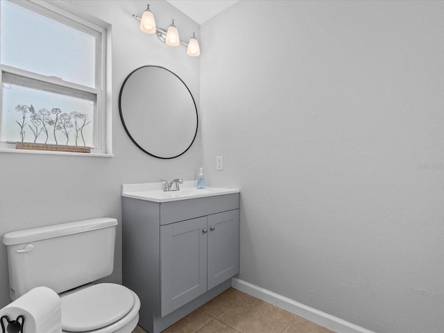 bathroom with vanity, tile patterned flooring, and toilet