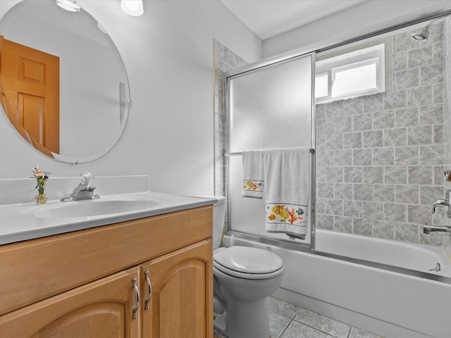 full bathroom featuring tile patterned floors, toilet, combined bath / shower with glass door, and vanity