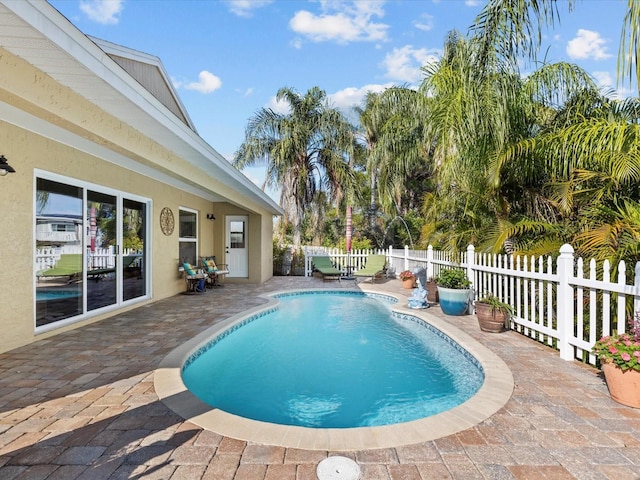 view of pool featuring pool water feature and a patio area